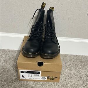 Dr. Martens black 8-eye leather combat boots with yellow welt stitching